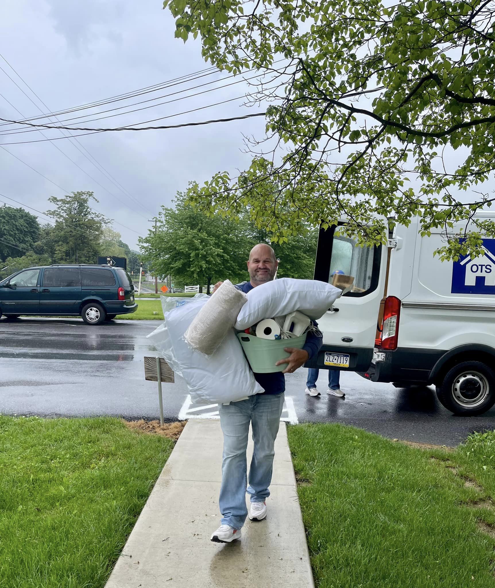 Volunteer carrying pillows